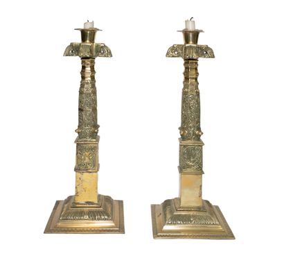 null Pair of ormolu and chased candlesticks with decorative and stylized motifs resting...