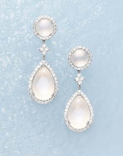 null A Pair of Moonstone and Diamond EarClips Each surmount designed as a circular...