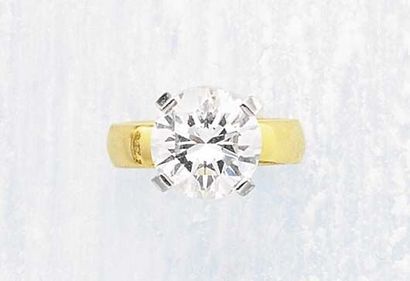 null A Diamond Ring center ing upon a circular-cut Diamond weighing approximately...