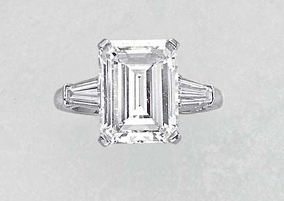 null A Diamond Ring Set to the center with a rectangular-cut Diamond weighing approximately...