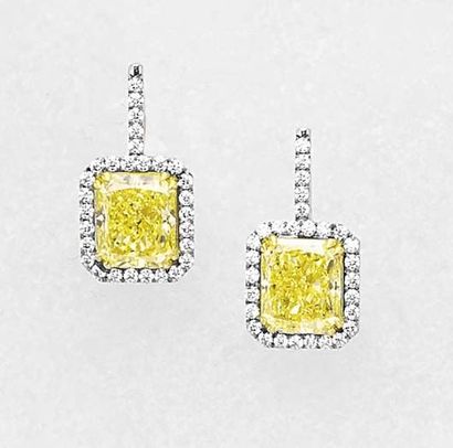 null An Important Pair of Fancy Intense yellow Diamond Ear Rings Each rectangular...