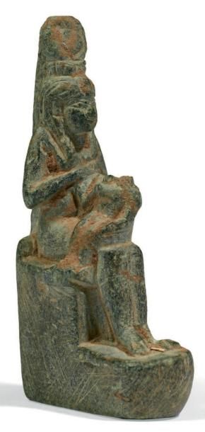 ÉGYPTE AMULETTE D'ISIS LACTANS. La déesse est assise, vêtue de la longue robe moulante,...