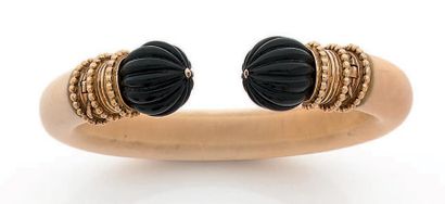 BOUCHERON 
Bracelet ouvrant en ivoire, les extrémités en boules côtelées d'onyx montées...