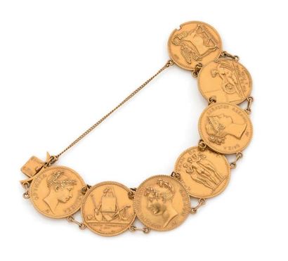 Bracelet en or 18K (750), articulé de 7 médailles...
