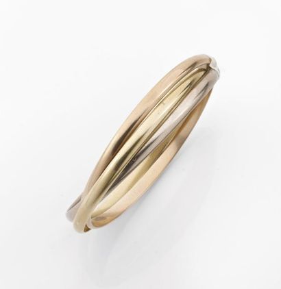 null CARTIER. Série contemporaine. BRACELET triple en ors de couleur. Signé et numéroté...