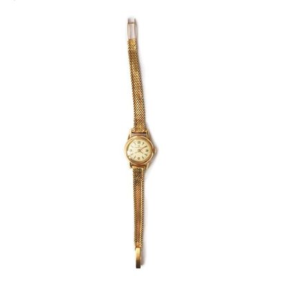 null Montre de dame en or jaune 18K, bracelet tresse et cadran signé "Eterna-matic"....