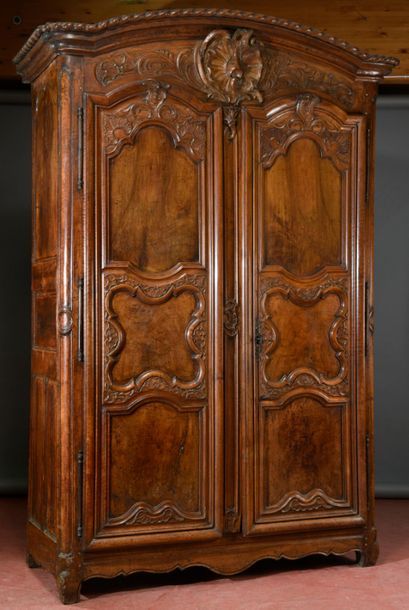 null Large moulded and carved walnut cupboard opening with two large-framed leaves...