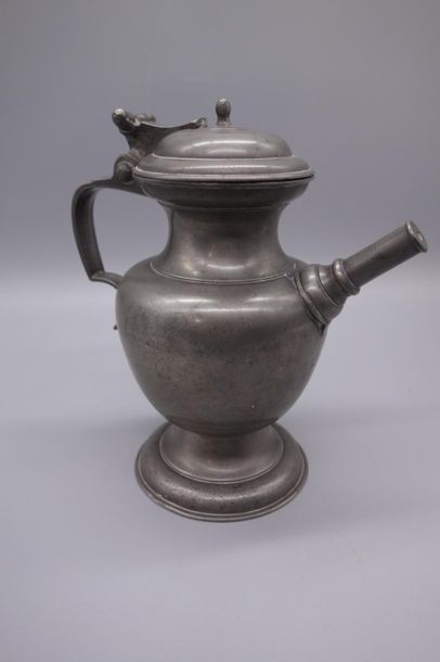null Beautiful pewter oil jug with baluster shape on pedestal, tubular spout, nipple...