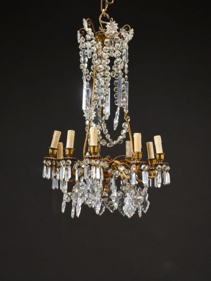 null Brass cage chandelier with ten light arms filled with pendants and plates. 
Circa...