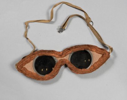 null Aviator glasses mounted on leather with a fur border, dark lenses.