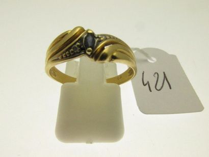 null 1 openworked two-tone gold ring set with a small shuttle sapphire set with two...