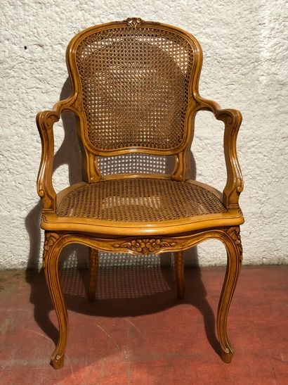 null Moulded and carved cherry wood cabriolet armchair with a cane base.

Louis XV...