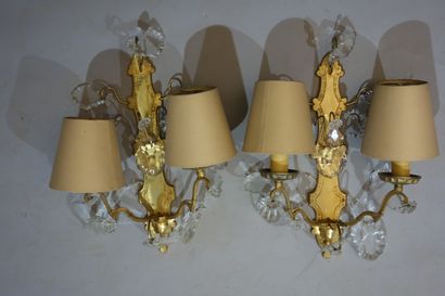 null A pair of gilt bronze sconces with crystal pendants, lighting two lights.