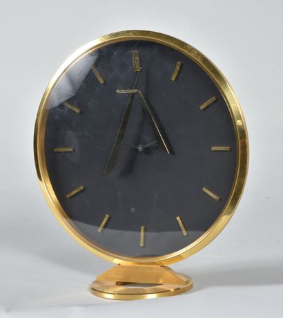  JAEGER LECOULTRE 
Brass table clock with circular body and dial with briquette numerals...