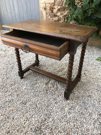  Small walnut table, turned uprights, flat H-shaped braces, opens in front with a...
