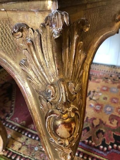 null A Regency style carved and gilded wood console table decorated with shells and...