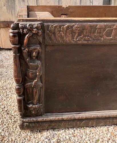  Walnut "cassonne" chest opening with a moulded top, carved on the front with characters...