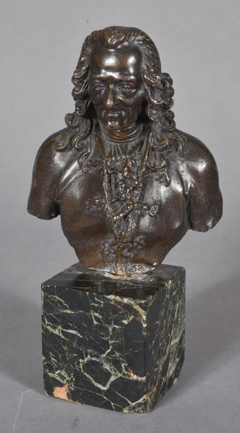  Buste en bronze patiné figurant le philosophe Voltaire, monté sur un socle en marbre....