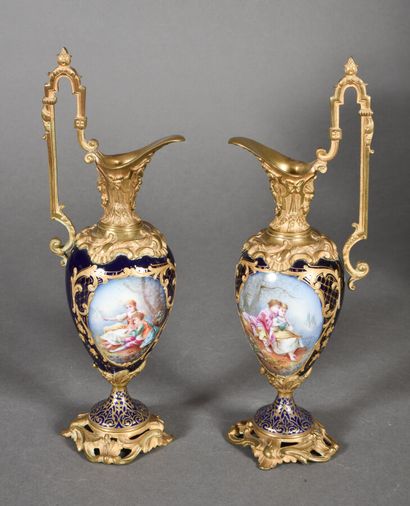 null Pair of ewers in the taste of Sevres with blue bottom decorated with polychrome...