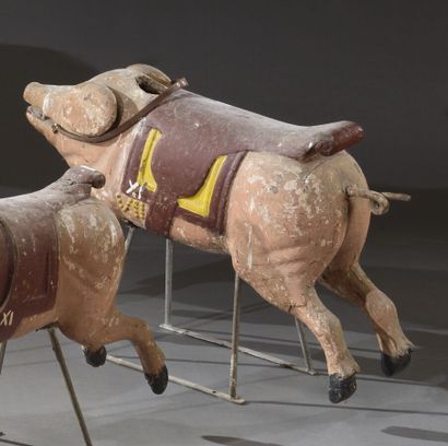 null Small carved wooden piggy, polychromed, on an iron tripod, with a stirrup.

19th...