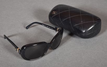  CHANEL. Paire de lunettes de soleil, monture acétate noir rehaussé d'un motif noeud....