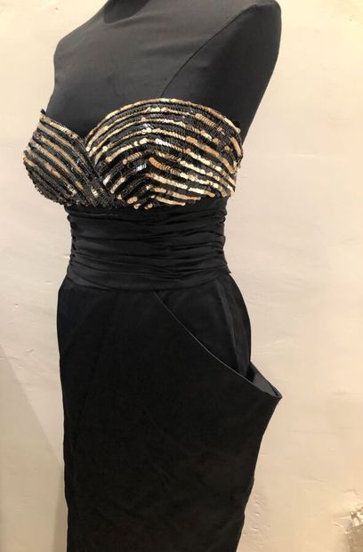  LORIS AZZARO. Long dress in black faille, strapless embellished with lines of gold...