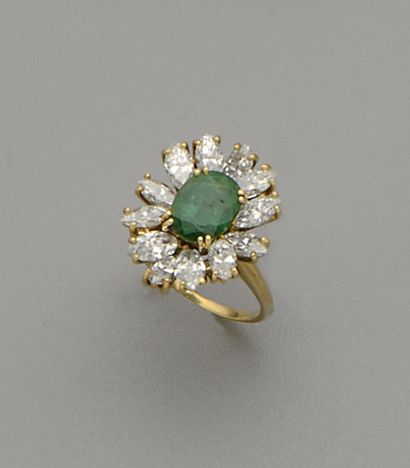 null 18K (750/oo) yellow gold "Flower" ring centered on an oval emerald weighing...