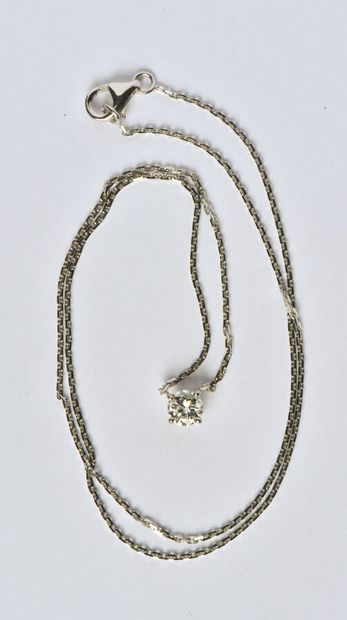  Collier en or gris 18K (750/oo) maille forçat centré d'un diamant taille brillant...