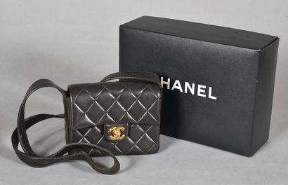 null CHANEL. Small black quilted leather bag, gold metal swivel clasp with logo on...