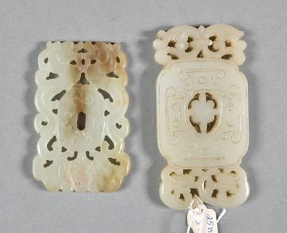null Two celadon jade pendants, one rectangular poly-lobed decorated in light relief...