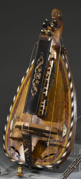 Hurdy-gurdy with head of man moustache of...
