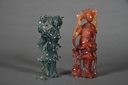 null Two statuettes, one in carnelian, the other in dark green amphibole, representing...