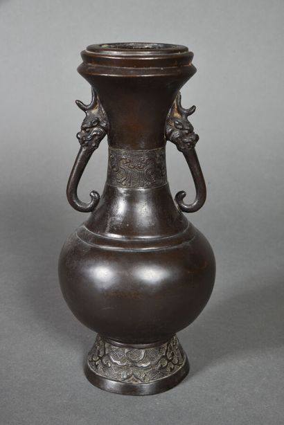 null Two bronze vases with a brown patina, one with a long neck and rounded body...