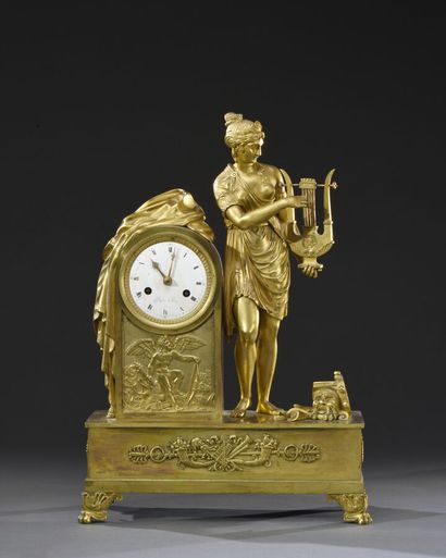 null Allegory of the music and the theater. Gilt bronze clock of terminal form, enamelled...