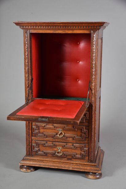 null Flemish style molded oak cabinet with carved lions' heads, opening with a flap...
