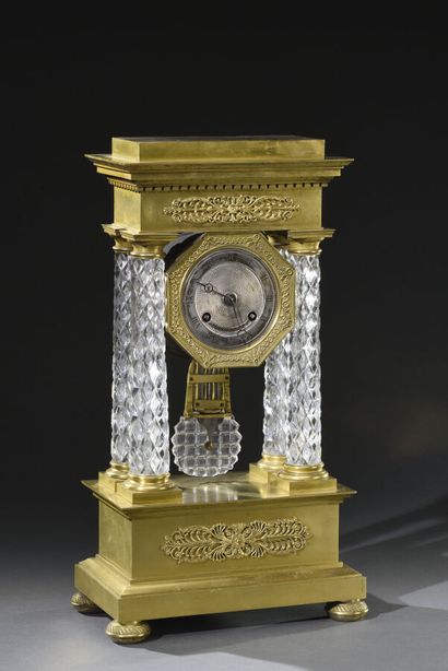 null Portico clock and its balance in gilded and engraved bronze decorated with foliage,...