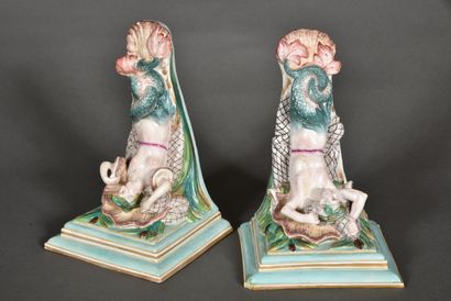 null Pair of wall brackets in polychrome and gold porcelain representing a triton...