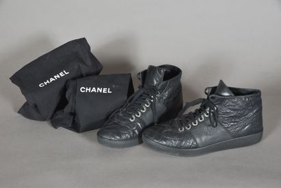 CHANEL. Pair of black quilted leather high-top...