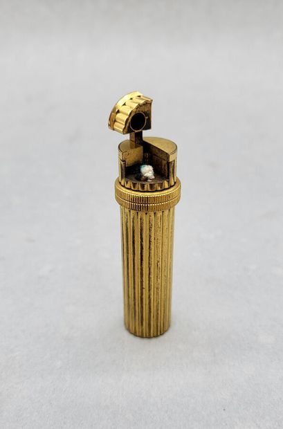null HERMES Paris.
Briquet cylindrique en métal doré godronné. Fabriqué en Suisse.
H6.5...