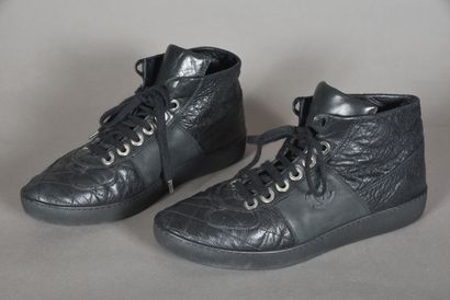 null CHANEL. Pair of black quilted leather high-top sneakers, laces on eyelets signed....