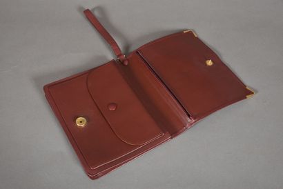 null CARTIER. Small document holder in burgundy leather stamped with the initials...