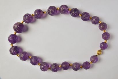 Necklace of carved amethyst beads in light...