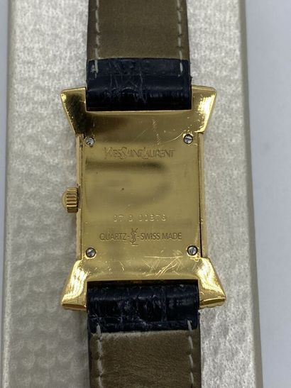 null YVES SAINT LAURENT. Watch with square dial white background set in a stylized...
