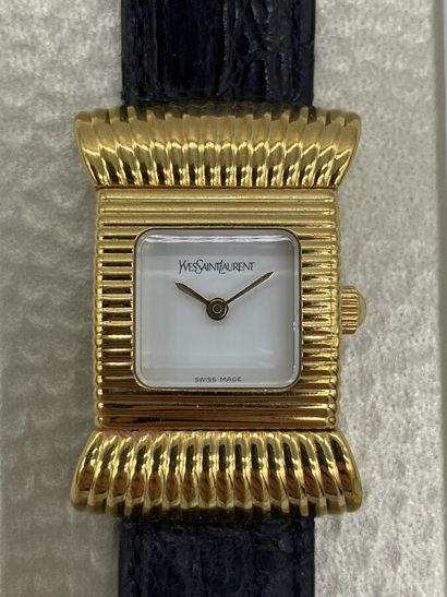 null YVES SAINT LAURENT. Watch with square dial white background set in a stylized...