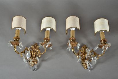 null A pair of gilt bronze sconces in the Louis XV style with two arms of light.
20th...