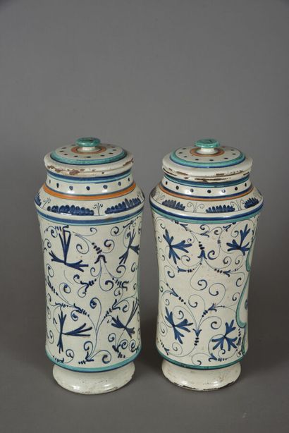null In the FAENZA taste. 
Two covered earthenware albarelli, with polychrome decoration...