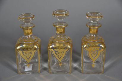 Three glass spirit flasks with gold palmettes...