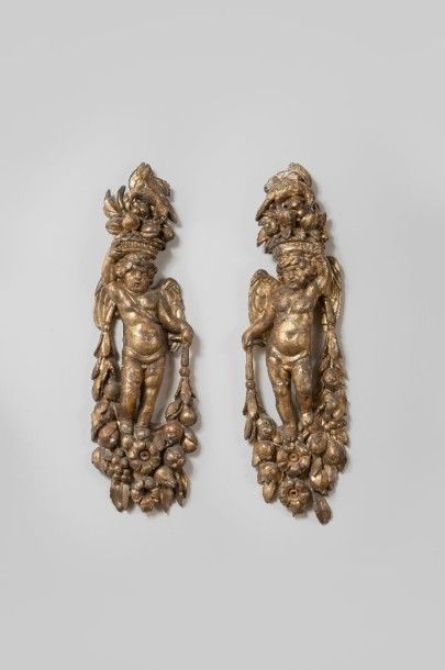 null Paire de sculptures en bois doré représentant deux angelots sur guirlandes fleuries...
