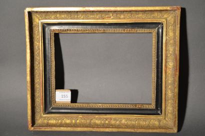 null FRAME in moulded wood and black and gold stucco with palmette and raise-de-coeur...