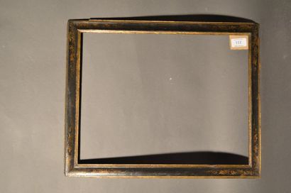 null RVERSE PROFILE FRAME in black and gold moulded wood with decoration in the corners...